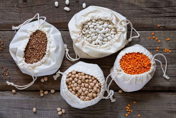 cotton-eco-bags-with-dried-raw-healthy-grain-top-view-rustic-wooden-table_224798-128